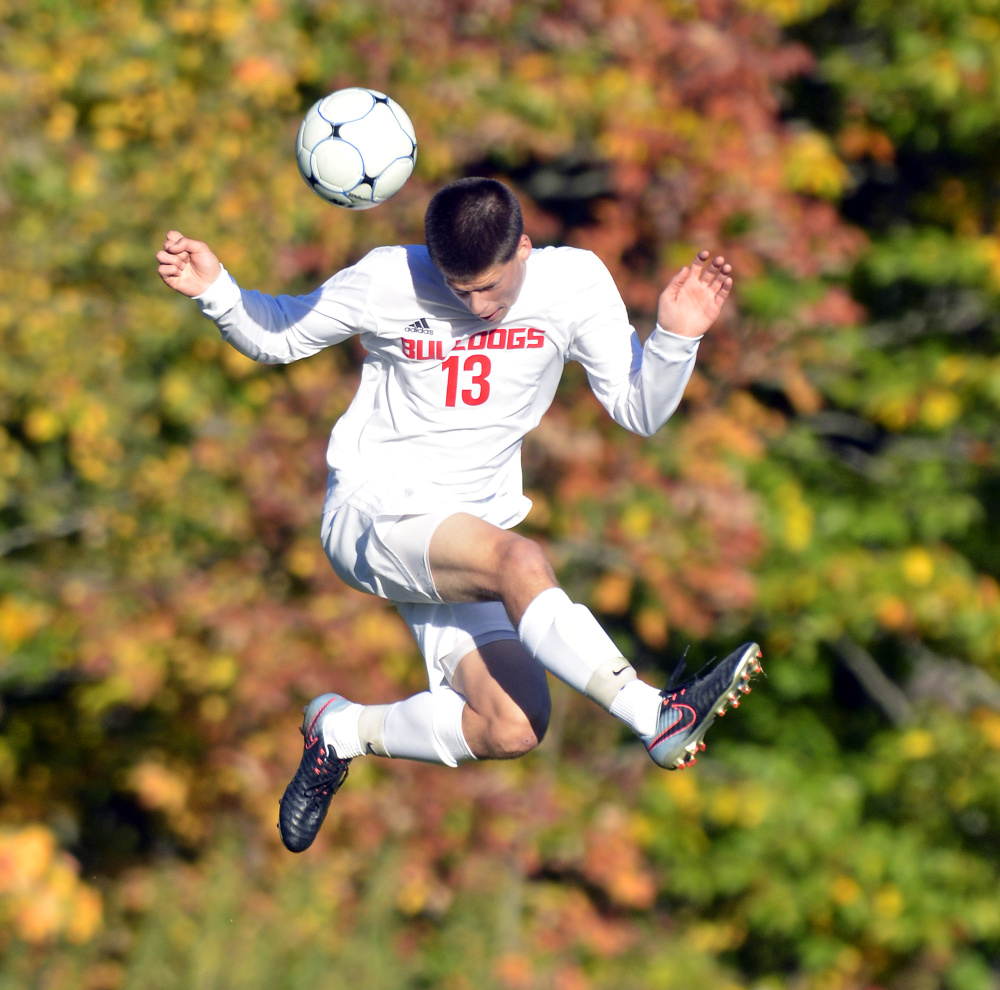 Hall-Dale's Matt Albert leaps up to head the ball during a game Thursday at Hall-Dale High School in Farmingdale.