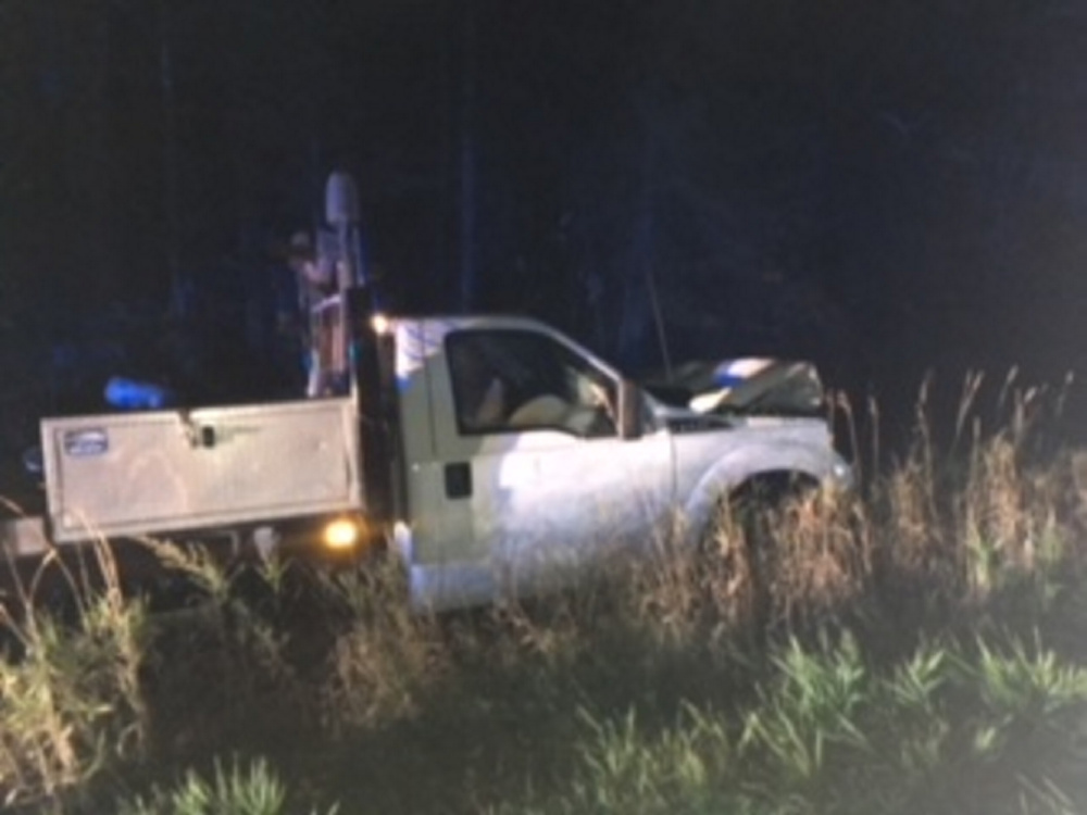 A Ford F-350 flatbed truck rests in a ditch in Madison Thursday night after it crashed. The driver was charged with OUI.