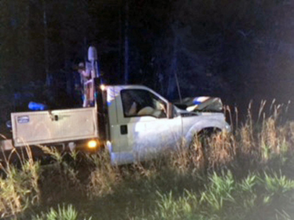 A Ford F-350 flatbed truck rests in a ditch Thursday night in Madison after it crashed. The driver was charged with operating under the influence.