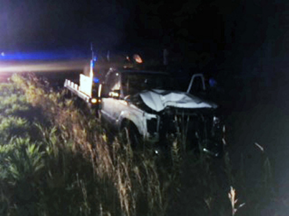 A Ford F-350 flatbed truck rests in a ditch Thursday night in Madison after it crashed. The driver was charged with operating under the influence.