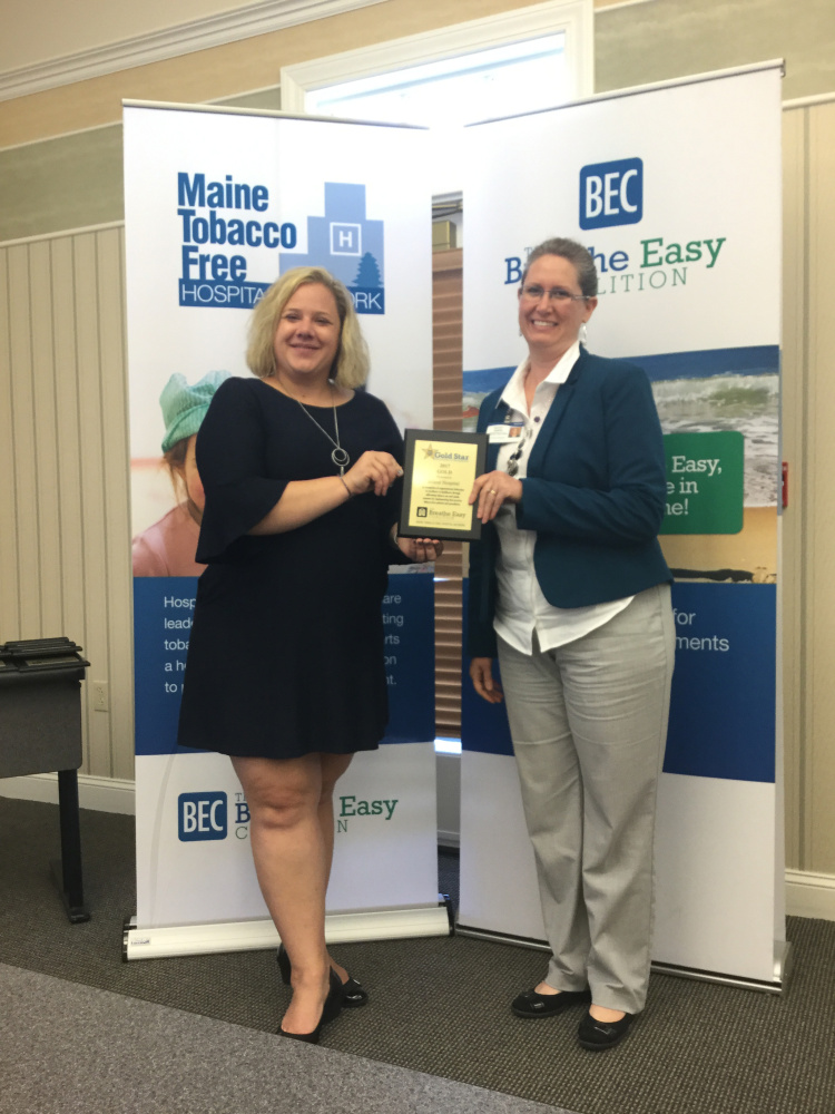 Sarah Mayberry, left program manager with the Tobacco Free Hospital initiative at the Center for Tobacco Independence, holds Inland Hospital's 2017 Gold Star in the Maine Tobacco-Free Hospital Network Awards with Kathy Jason, communications specialist and member of the Inland/Lakewood Total Health team.