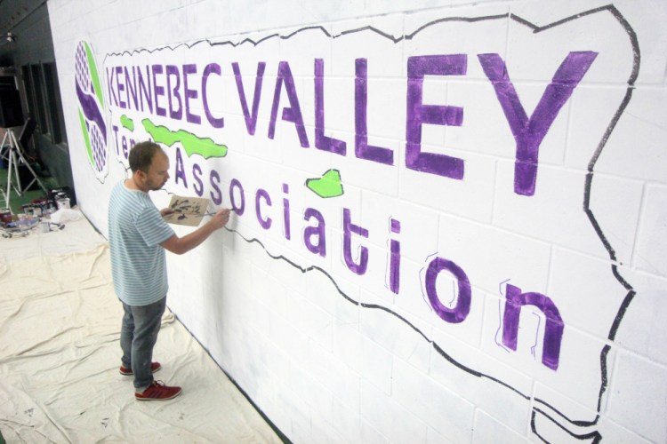 Gardiner artist Matt Demers paints a mural during an "Art on the Courts" fundraiser in Augusta on Sunday to benefit Maine General's OutPatient Plus Program and the Kennebec Valley Tennis Association.