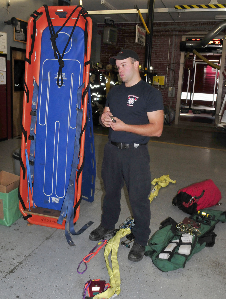 Skowhegan firefighter Scott Libby on Monday displays a Stokes basket and gear that he and firefighters from Skowhegan and Norridgewock used to rescue a Mercer man after he seriously cut his ankle with an ax on Sunday. It took about 300 feet of rope and 14 firefighters to haul him up from the riverside to the top of the steep embankment in a Stokes basket on Sunday.