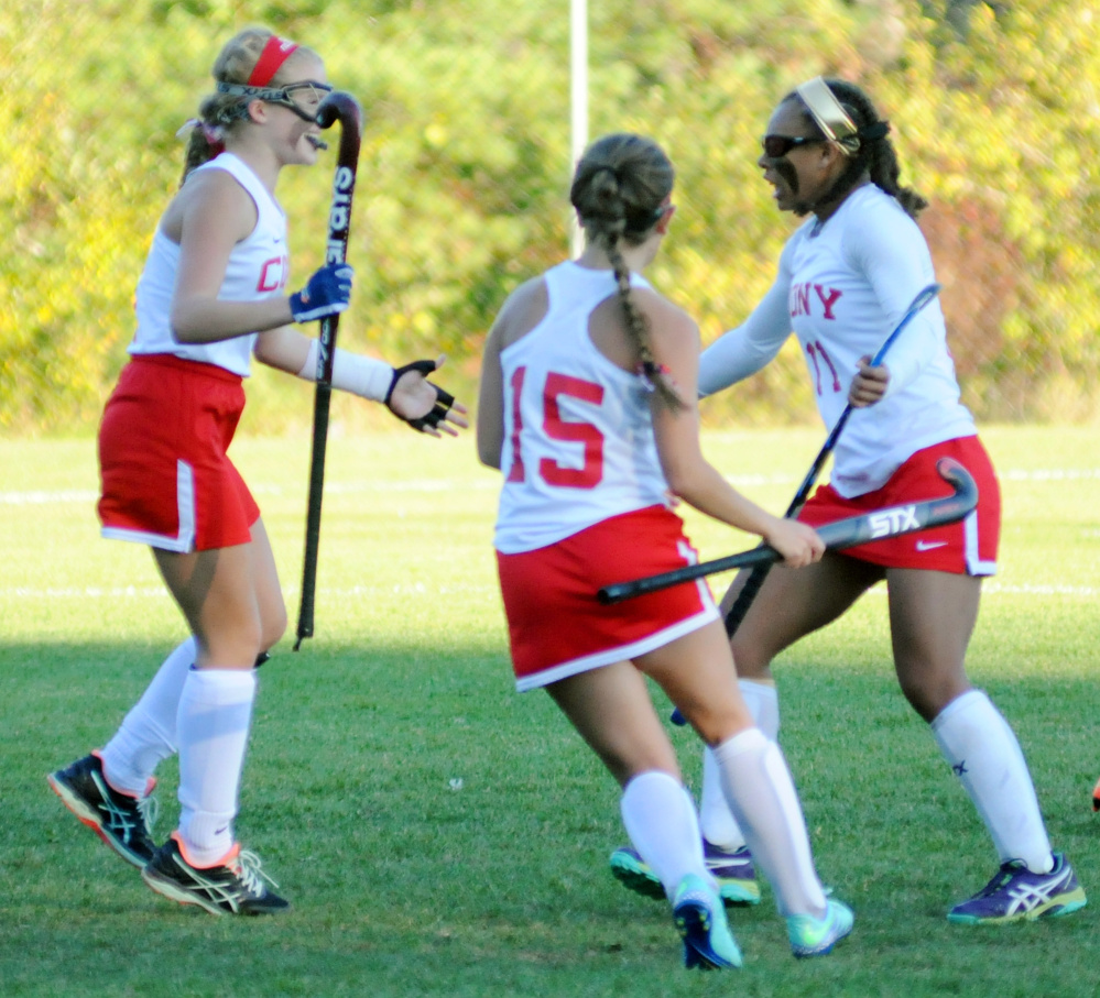 Cony's Julia Reny, left, and Faith Leathers-Pouliot rush in to hug teammate Kami Lambert after she scored an overtime goal to beat Mt. Ararat in a Class A North quarterfinal game Tuesday in Augusta.