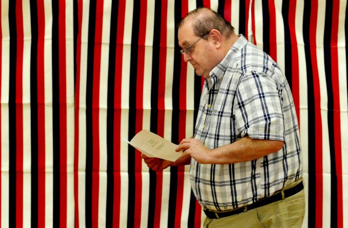 School Administrative District 13 board Chairman Brian Mallow looks over his ballot July 25 before casting it at Quimby School in Bingham. Residents of Bingham and Moscow passed the school budget by six votes in the Tuesday referendum, the fourth time the budget had gone to a referendum.