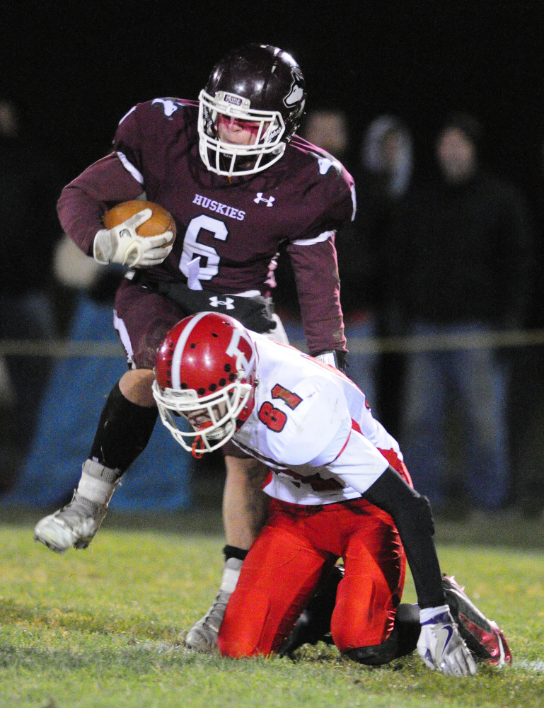 MCI running back Adam Bertrand, top, evades Dexter defender Jason Campbell en route to scoring touchdown during the Little Ten Conference championship game last year at Alumni Field in Pittsfield.