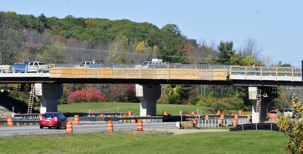 Workers complete the bridge replacement work Friday before re-opening the Winthrop Street bridge over Interstate 95 in Hallowell.
