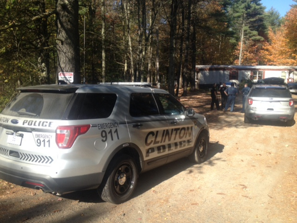 Maine State Police, with a tracking dog, and Clinton police confer Saturday afternoon at the scene on Hinckley Road in Clinton where a stabbing was reported. A male juvenile was arrested later nearby in connection with the incident.