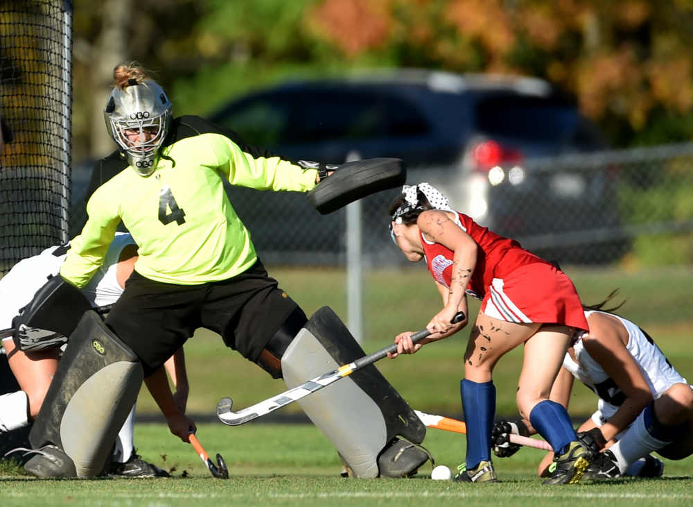Skowhegan goalie Leah Savage makes a save on a shot from Messalonskee forward Chloe Tilley, right, during a Class A North game earlier this season in Skowhegan.
