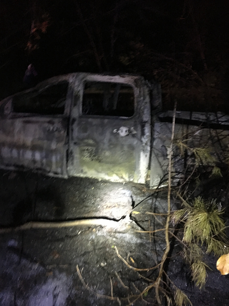 A pickup truck that crashed into a utility pole was destroyed by an ensuing fire on the Red Bridge Road Sunday evening. The driver fled on foot but turned himself in Monday to the Skowhegan police.