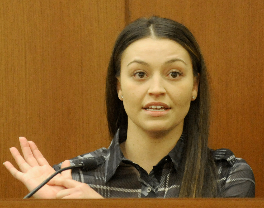 Danielle Jones, the co-owner of two dogs that have been ordered euthanized, displays scars while testifying Nov. 29, 2016, that she claims are from wounds she suffered while breaking up a dog fight at her Winslow home.