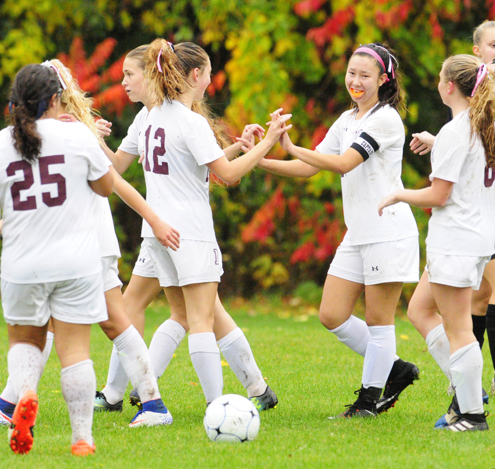 Teammates congratulate Monmouth's Tia Day, second from right, after she scored her fourth goal against Maranacook in a Class C South quarterfinal game Tuesday at Monmouth Academy.