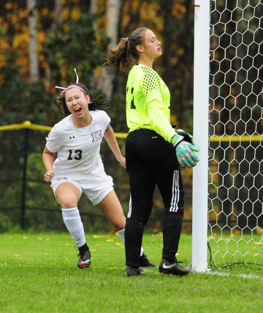 Monmouth's Tia Day, left, celebrates after scoring her third goal in a 4-0 shutout of Maranacook in a Class C South quarterfinal game Tuesday at Monmouth Academy. Maranacook keeper Skyeler Webb is at right.