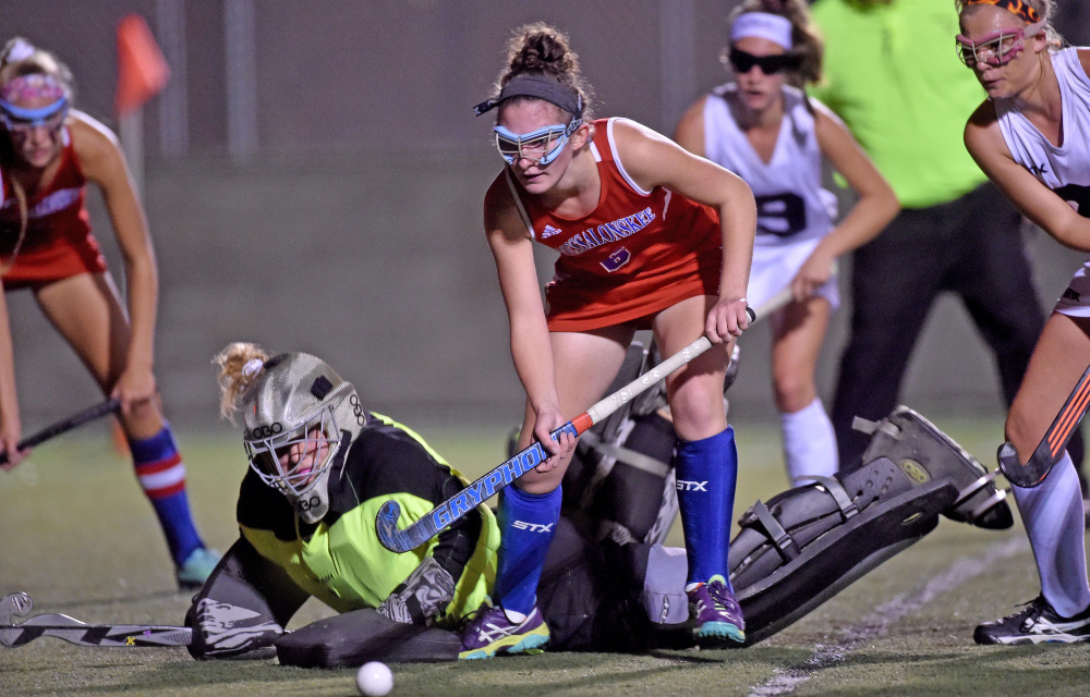 Skowhegan goalie Leah Savage (4) makes a diving save as Messalonskee's Kaitlyn Smith (6) looks for the rebound during the Class A North championship game Tuesday at Hampden Academy.