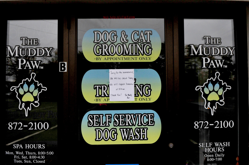 A sign on the front door of the Muddy Paw business in Winslow said the business was closed Wednesday. The shopkeeper, Danielle Jones, owns two pit bull dogs that have been ordered to be euthanized for killing a puppy in 2016. The dogs reportedly got loose Tuesday while being walked by Jones at the Humane Society Waterville Area.