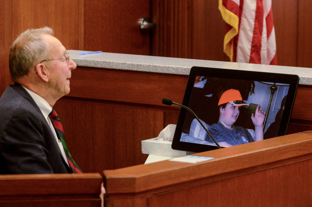 Andrew Balcer's grandfather Arthur Pierce, 82, looks at photo of Balcer during a hearing Thursday in Augusta to determine whether Balcer should be tried as an adult for allegedly killing his parents.