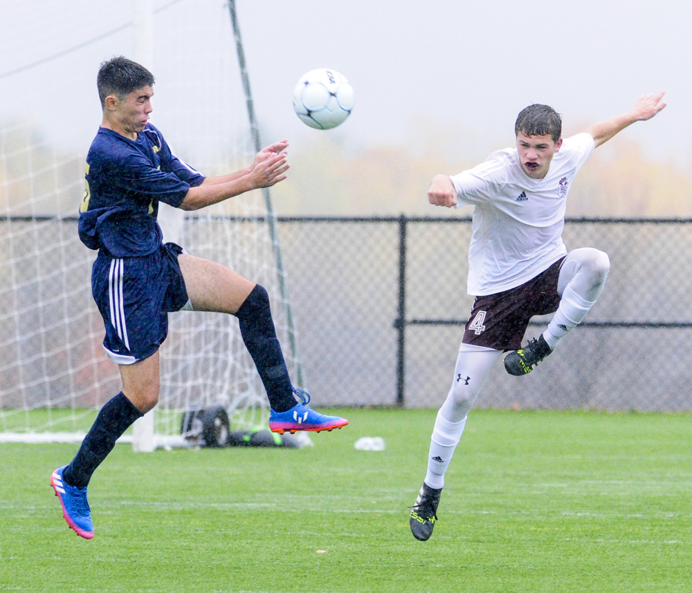 Traip's Pablo Lopez Zapata, left, and Monmouth's Thomas Neal go up for a ball during a rain soaked Class C South quarterfinal game Thursday at Kents Hill School.