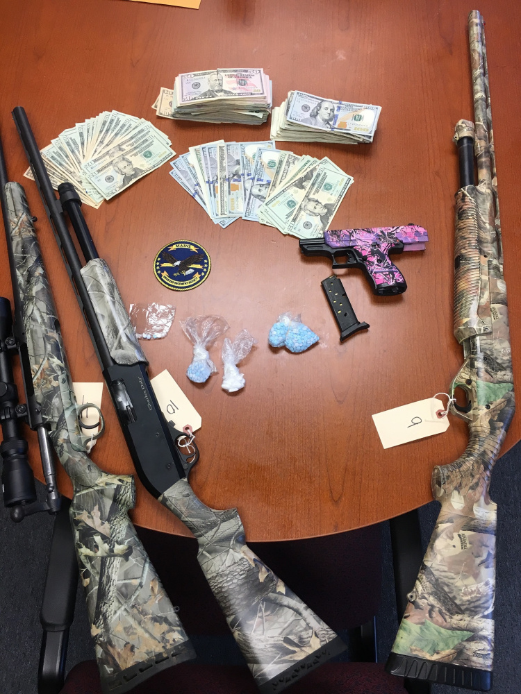 Some of the cash, guns and drugs confiscated from a home in Jefferson after a yearlong investigation by the Maine Drug Enforcement Agency.