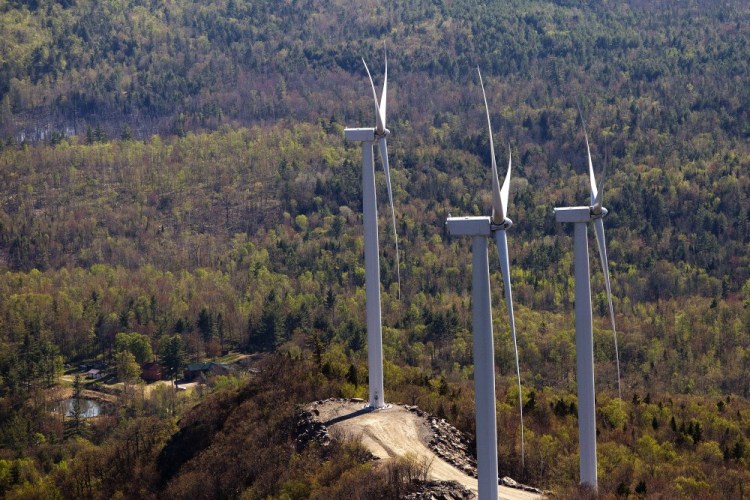 Three wind turbines owned by Patriot Renewables are seen on May 14, 2015, along Saddleback Ridge in Western Maine.