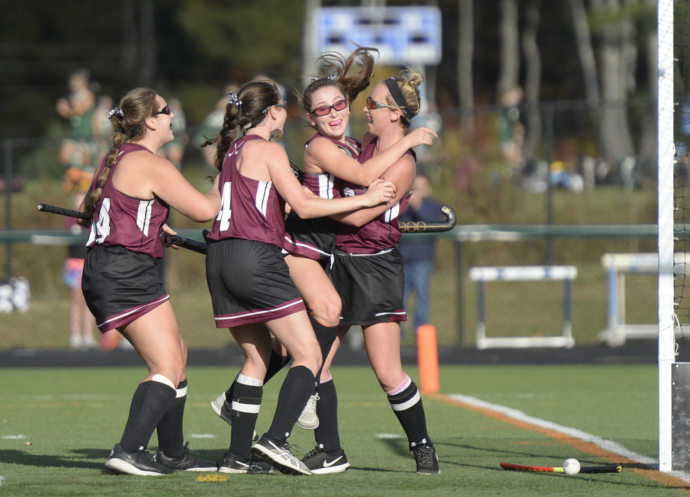 Maine Sunday Telegram photo by Shawn Patrick Ouellette 
 Members of the maine Central Institute swarm Vivian Duncombe, second from right, after Duncombe scored in the second half of the Class B state championship game Saturday at Falmouth High School