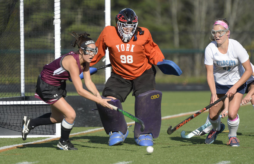 York goalie Julianna Kiklis and Caroline Leal defend the goal as MCI's Madisyn Hartley tries to get off a shot during the Class B state championship game Saturday at Falmouth High School.