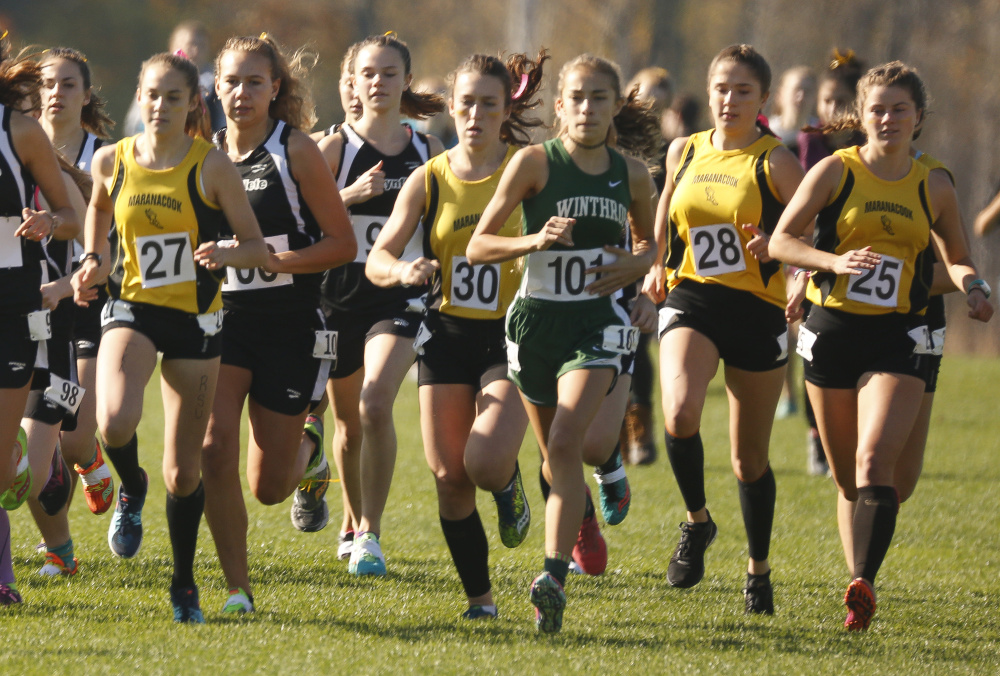 Maranacook team members, including Molly McGrail (27), Dana Reynolds (30), Sophie O'Clair (28) and Madelyn Dwyer (25) run with the pack during the start of the Class C cross country state championship meet Saturday at Twin Brooks Recreation Area in Cumberland.