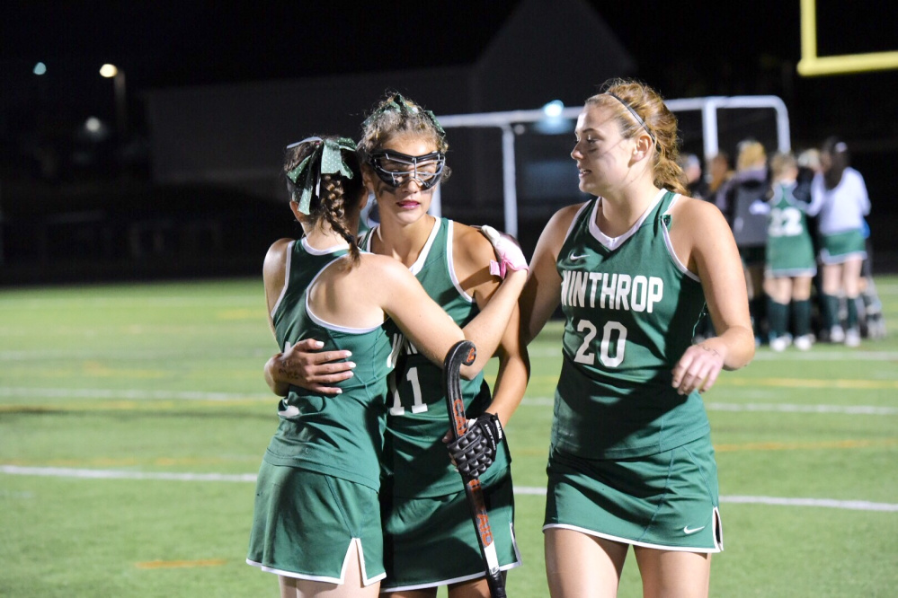 Winthrop players Kinli DiBiase, center, comforts teammates Nora Conrad, left, and Elle Blanchard after they fell to St. Dominic in the Class C state championship game Saturday at Falmouth High School.