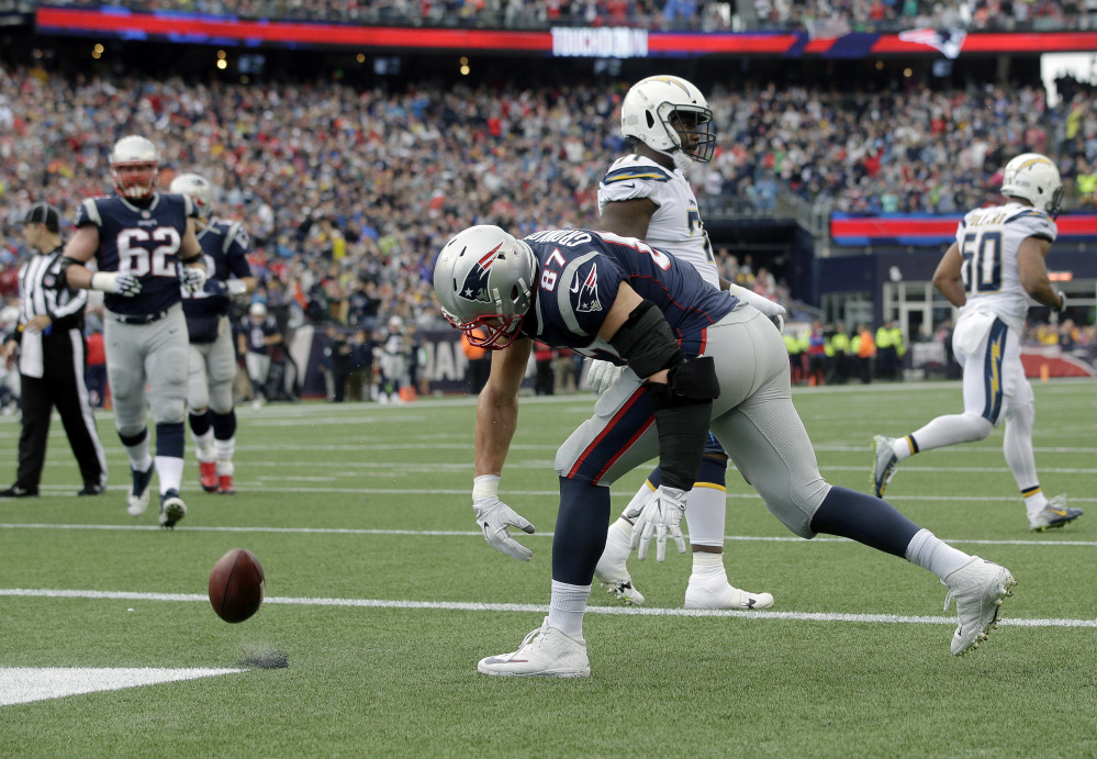 New England Patriots tight end Rob Gronkowski spikes the ball after catching a touchdown pass against the Los Angeles Chargers during the first half Sunday in Foxborough, Massachusetts.