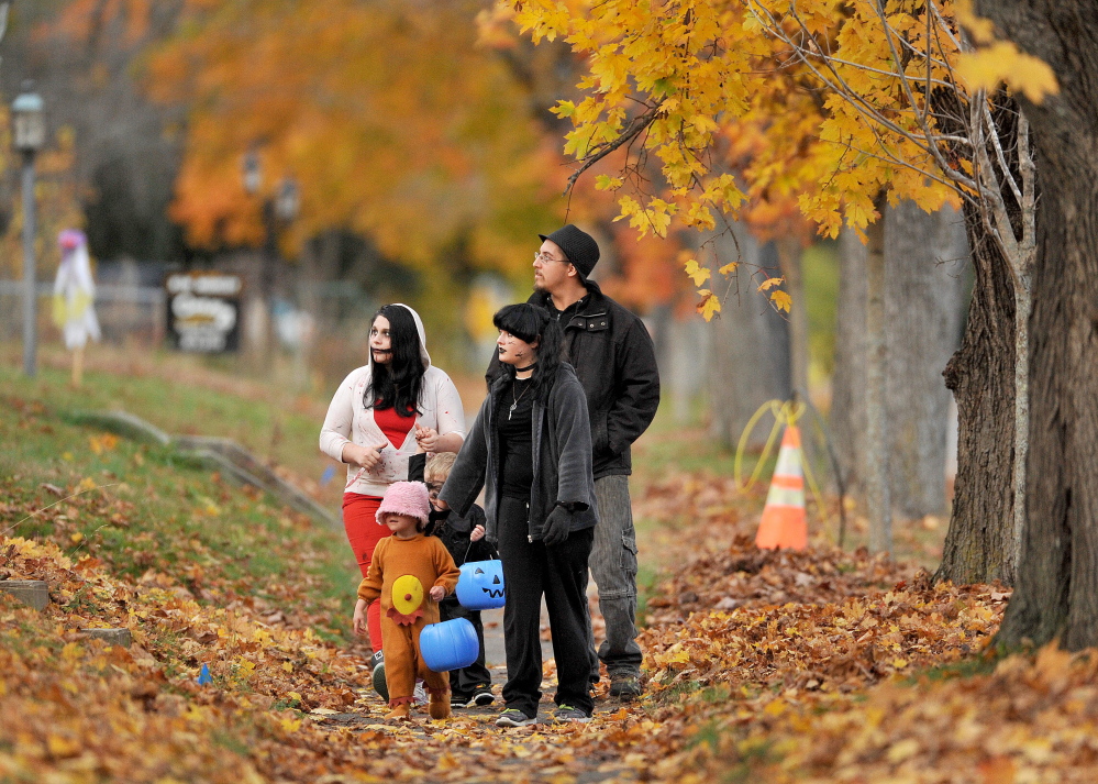 Trick-or-treaters walk down Burliegh Street looking for candy on Oct. 31, 2014.