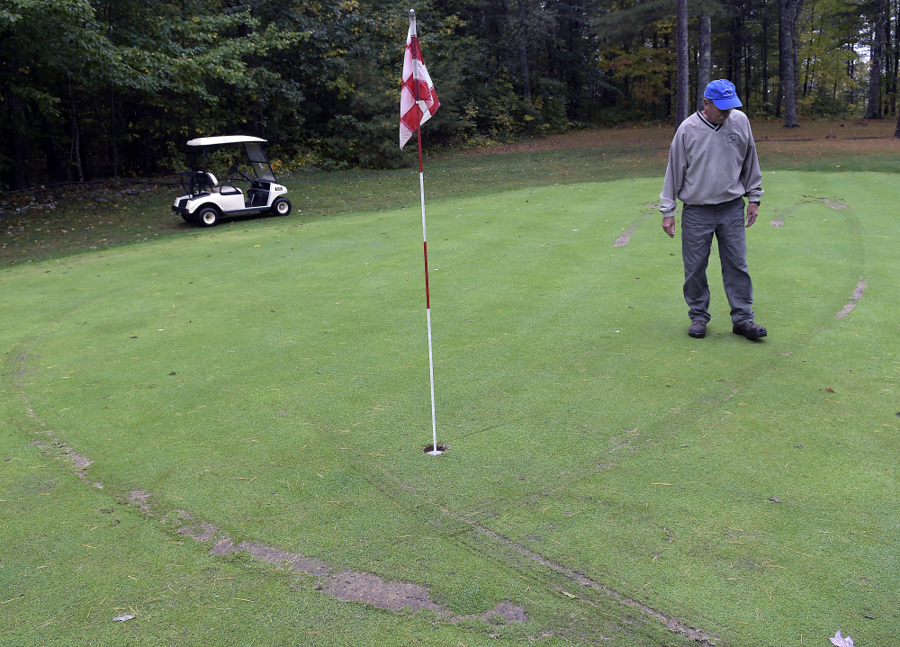 Ruts from golf carts surround Bill Sylvester Oct. 9 on the second green at Cobbossee Colony Golf Course in Monmouth.