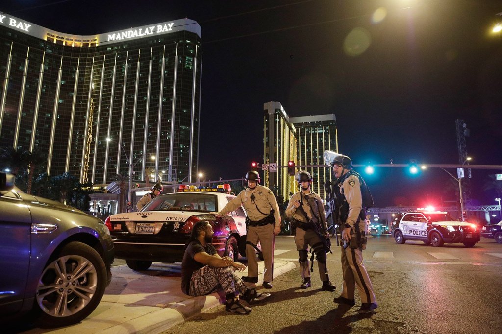 Police officers stand at the scene of a shooting near the Mandalay Bay resort and casino on the Las Vegas Strip.