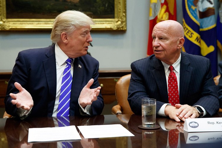 Rep. Kevin Brady, R-Texas, right, listens as President Trump speaks during a September meeting with members of the House Ways and Means committee in the Roosevelt Room of the White House.  Brady says he’s discussing the 401(k) issue with Trump, who earlier this week shot down the possibility of changes to the popular savings program. 