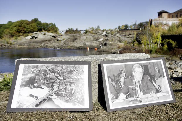 Pictures of U.S. Sen. Edmund Muskie of Maine and of pollution piled up below the Great Falls in Lewiston and Auburn sit near the riverbank during a news conference Tuesday.