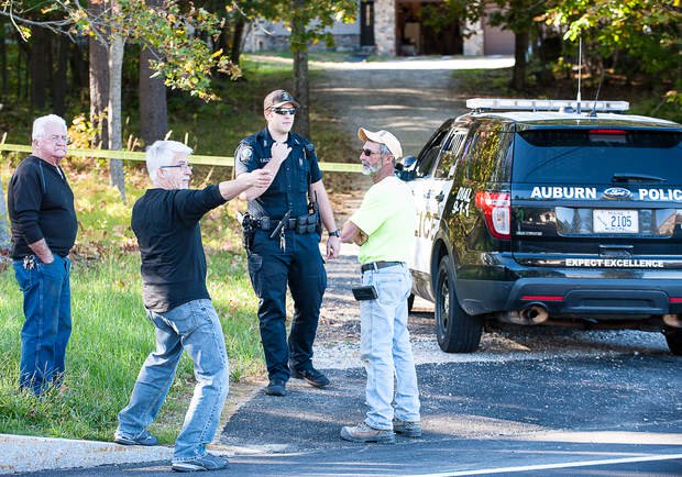 Michael Koch, center, explains to Auburn Police Officer Thomas Ellis that he met a burglary victim at her home on Park Avenue in Auburn on Thursday afternoon after she freed herself. 
