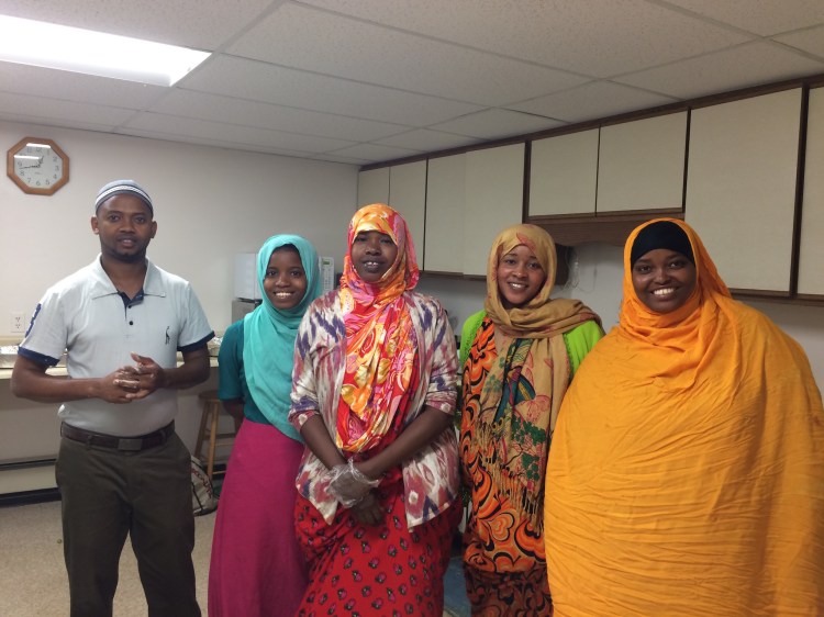 In the kitchen at the Beyond Borders Somali food luncheon, from left:  Mohamed Dekow, Deko Hassan, Asli Hussein, Khadija Noorow and  Khadija Hussein. Dekow is executive director of the Sustainable Livelihoods Relief Organization in Lewiston.