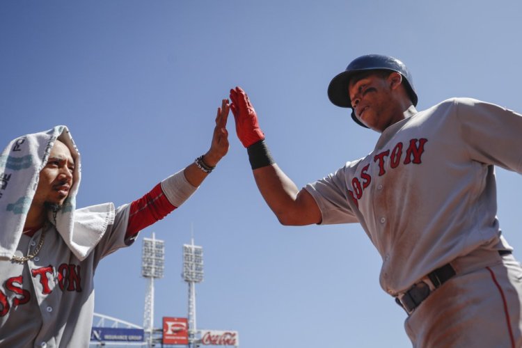 Boston's Rafael Devers, right, celebrates with Mookie Betts, left, after hitting a solo home run off Cincinnati starting pitcher Jackson Stephens in the fifth inning of the Red Sox' 5-4 win Sunday in Cincinnati.