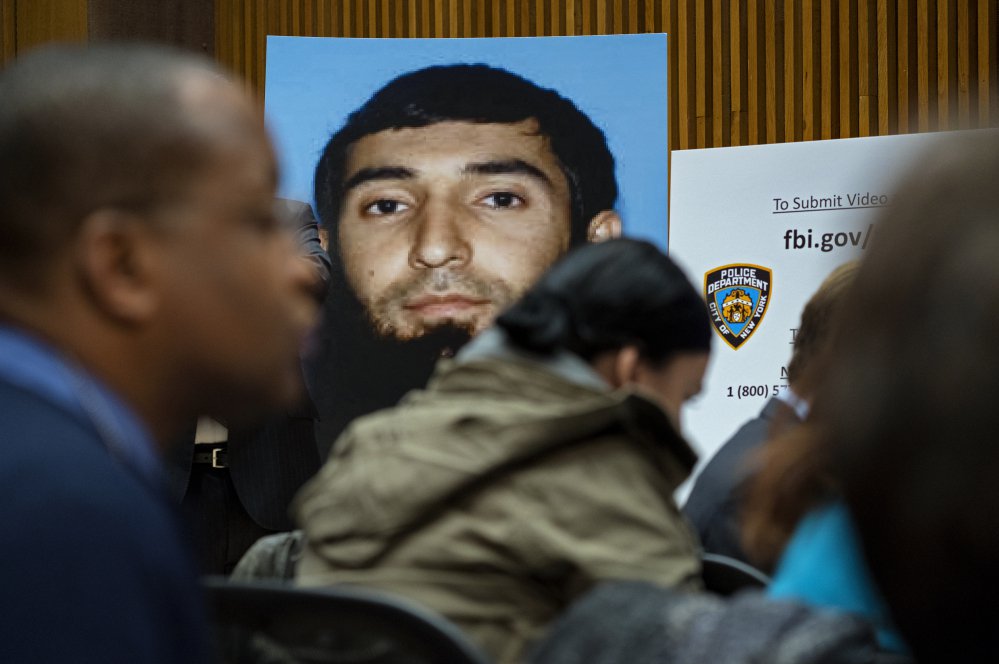 A photo of Sayfullo Saipov is displayed at a news conference at One Police Plaza on Wednesday in New York. Saipov is accused of driving a truck on a bike path that killed eight people and seriously injured others Tuesday near the World Trade Center memorial.