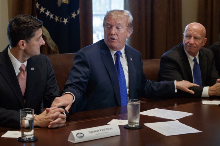 President Trump speaks during a meeting on tax policy with Republican lawmakers in the Cabinet Room of the White House on Thursday in Washington, with House Speaker Paul Ryan of Wisconsin, left, and Chairman of the House Ways and Means Committee Rep. Kevin Brady, R-Texas.