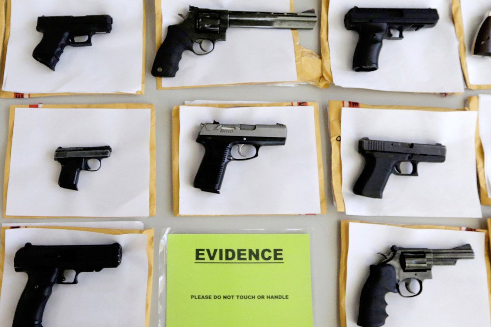 In this July 7, 2014 file photo, Chicago police display some of the thousands of illegal firearms confiscated during the year. In a government report released on Friday, Nov. 3, 2017, the U.S. rate for gun deaths has increased for the second straight year, following 15 years of no real change.