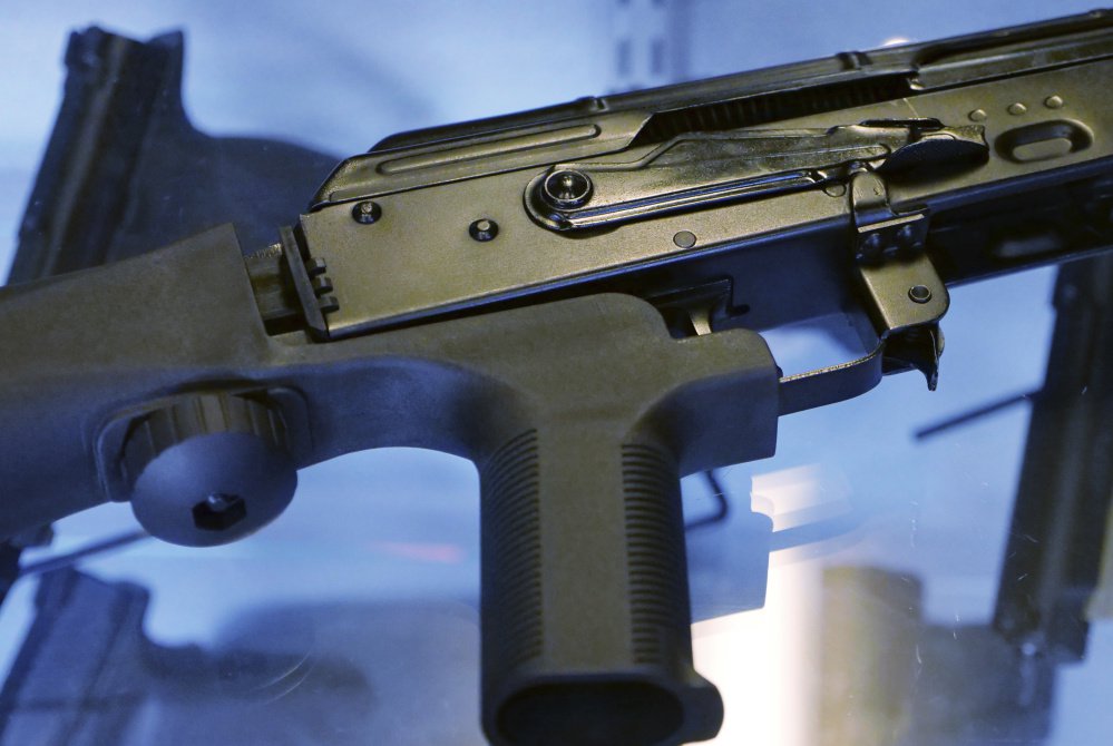 A bump stock is attached to a semi-automatic rifle at the Gun Vault store and shooting range in South Jordan, Utah.
