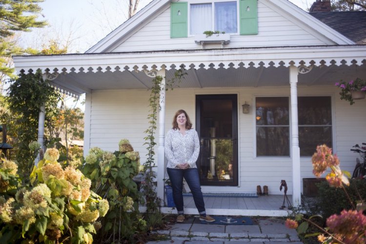 Cara Gaffney outside of the home that she and her husband bought in 2005. They later found out the home was built as a summer cottage by cookbook author Lily H. Wallace in the 1920s.