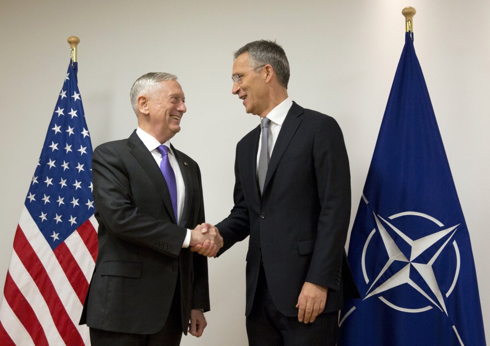 U.S. Secretary for Defense Jim Mattis, left, shakes hands with NATO Secretary General Jens Stoltenberg at NATO headquarters in Brussels on Wednesday