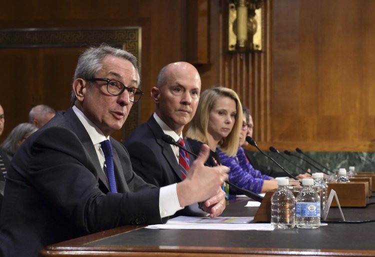 Paulino do Rego Barros, Jr., left, interim CEO of Equifax, Inc., sitting with Richard Smith, center, former CEO of Equifax, Inc., and former Yahoo! CEO Marissa Mayer, right, testifies Wednesday before the Senate Commerce Committee on Capitol Hill during a hearing on "Protecting Consumers in the Era of Major Data Breaches."