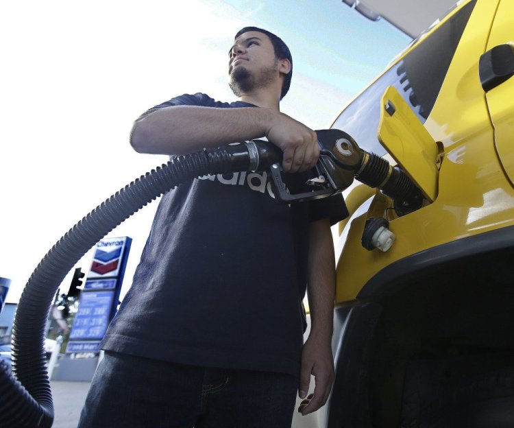 Cristian Rodriguez fuels his vehicle Oct. 30 in Sacramento, Calif. A more widespread use of electric cars will not be enough to consign oil to the past, the IEA director says.