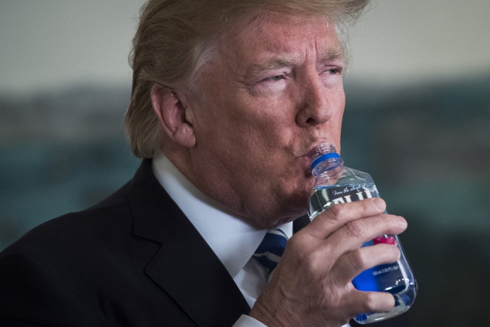 President Trump takes a drink of water as he speaks about his trip to Asia on Wednesday. Trump did not respond to questions about the troubled Senate candidacy of Roy Moore in Alabama.