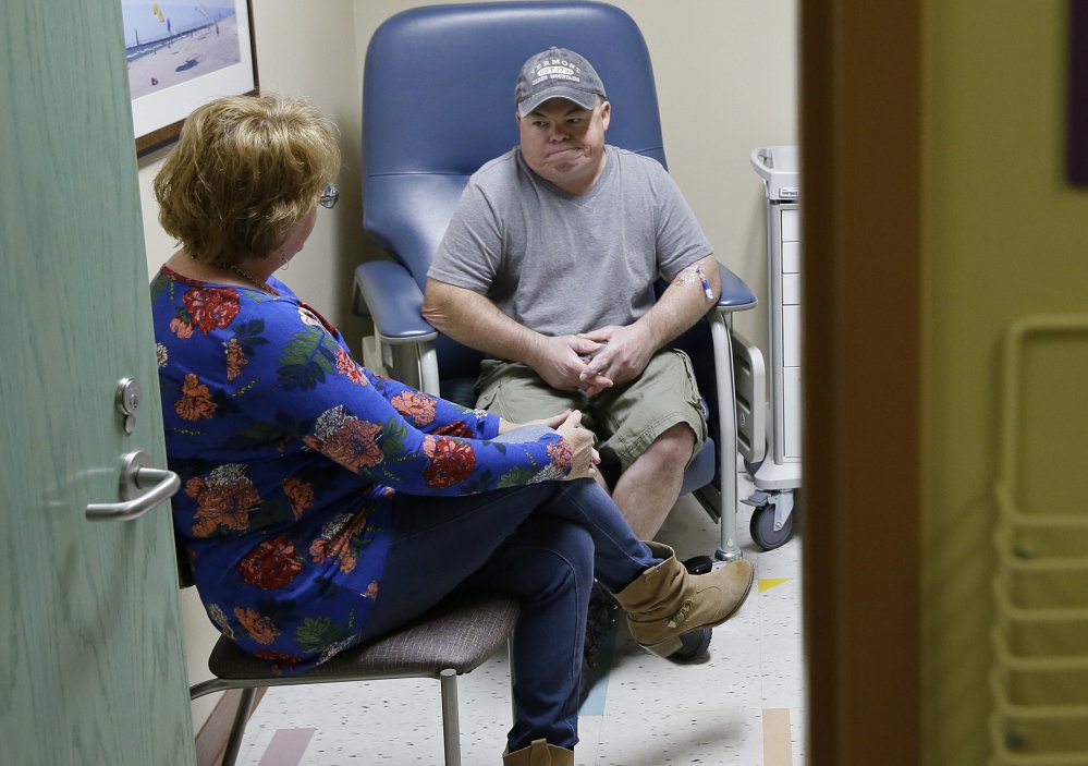 Brian Madeux, who has Hunter syndrome, waits with Marcie Humphrey, at the Oakland, Calif., hospital where an experimental gene therapy took place Monday to combat his disease.