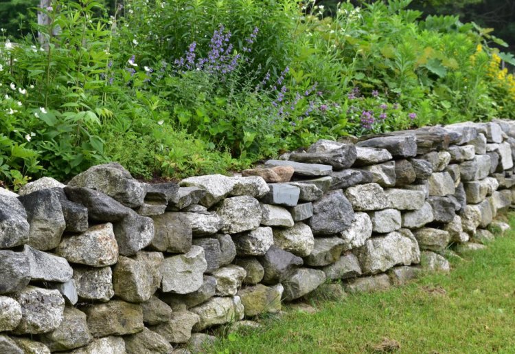 Features like stone walls should inform your garden design.