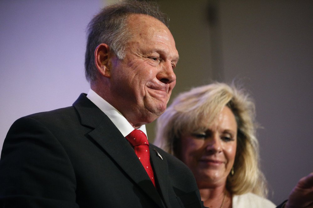 U.S. Senate candidate Roy Moore speaks at a news conference Thursday in Birmingham, Ala., with his wife, Kayla Moore.
