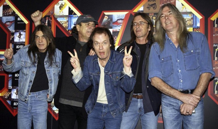 The members of AC/DC, Malcolm Young, from left, Brian Johnson, Angus Young, Phil Rudd and Cliff Williams, pose in 2003 at the Apollo Hammersmith in London. Young, the rhythm guitarist and guiding force behind the bawdy hard rock band AC/DC who helped create such head-banging anthems as “Highway to Hell,” “Hells Bells” and “Back in Black,” was reported to have died in November. He was 64 and had suffered from dementia for years.