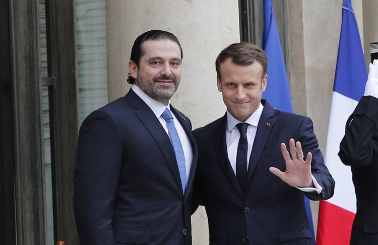 French President Emmanuel Macron, right, greets Lebanon's Prime Minister Saad Hariri in Paris on Saturday. Hariri wants to dispel fears that he had been detained in Saudi Arabia.